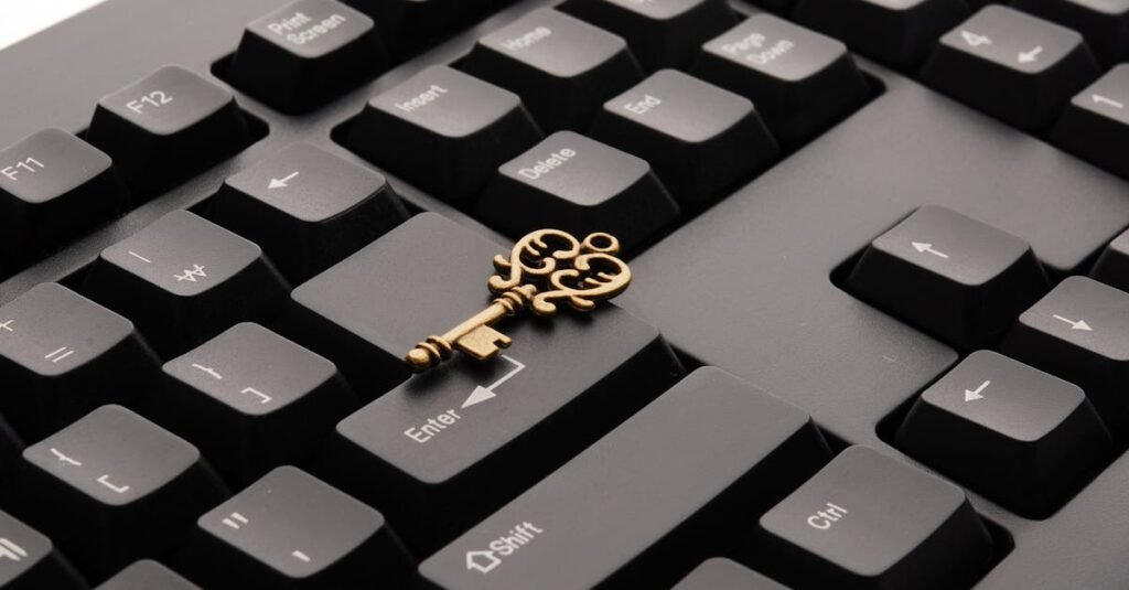 Close-up of an ornate vintage key placed on a modern computer keyboard.